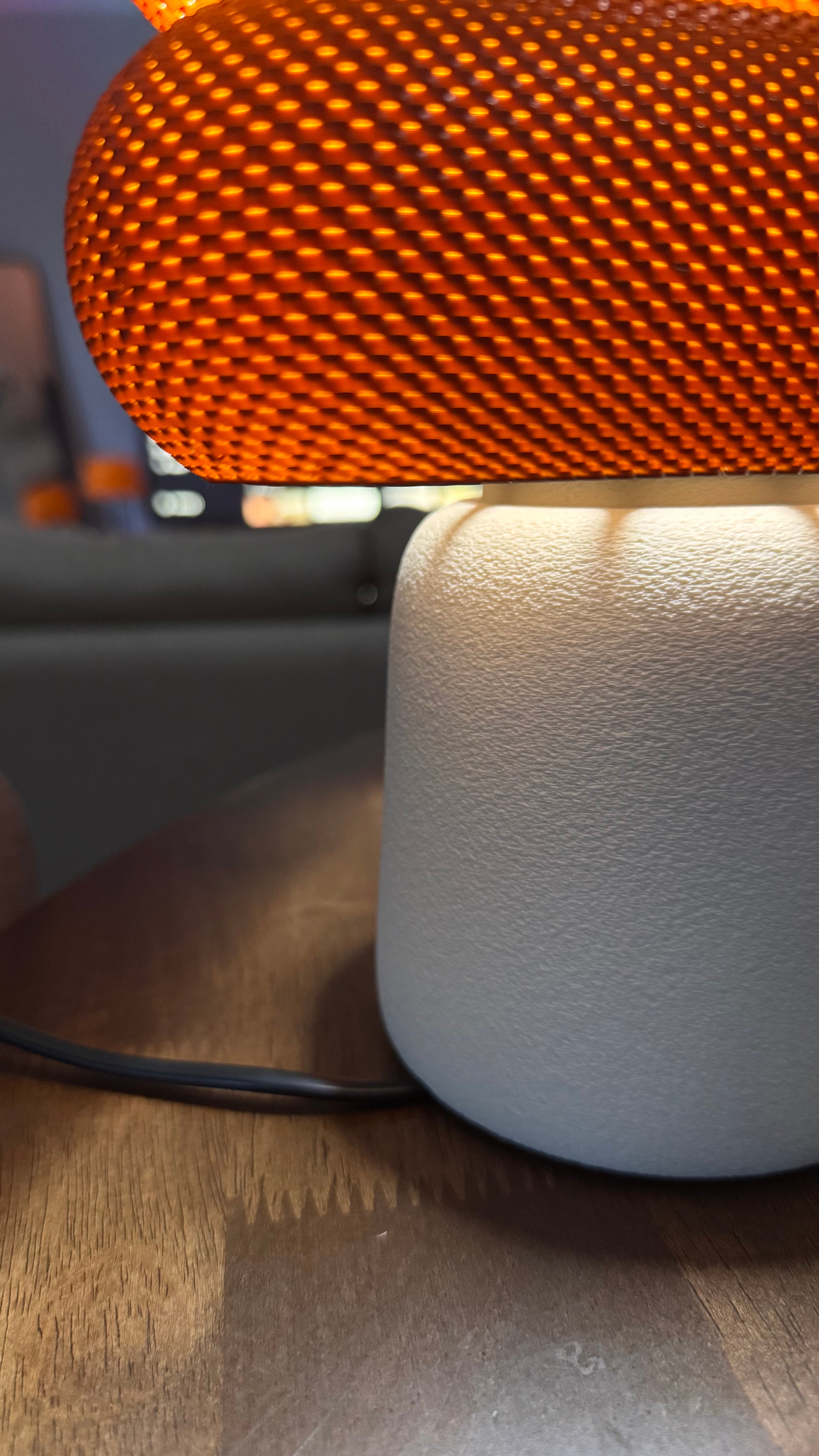 Lamp with orange textured shade on a wooden surface
